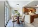 Cozy dining area showcasing a round table, four chairs, and natural light from the sliding glass doors at 2409 E Magnolia St, Lakeland, FL 33801