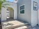 Detail of the entrance of this single Gathering home with an arched entryway and tiled terrace at 2409 E Magnolia St, Lakeland, FL 33801