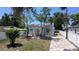 Home with an arched entryway, red tile roof, and a neatly landscaped front yard at 2409 E Magnolia St, Lakeland, FL 33801