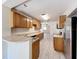 Bright kitchen featuring wood cabinets, light countertops and flooring, and stainless steel appliances at 2409 E Magnolia St, Lakeland, FL 33801