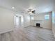 Open-concept living room with a ceiling fan, fireplace, and plenty of natural light at 2409 E Magnolia St, Lakeland, FL 33801