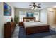 Comfortable main bedroom with a ceiling fan, two windows, and neutral decor at 2409 E Magnolia St, Lakeland, FL 33801