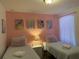 Charming bedroom featuring twin beds, Disney-themed artwork, and a cozy ambiance at 2514 Dharma Cir, Kissimmee, FL 34746