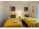 Bright twin bedroom featuring playful music themed art and vibrant yellow bedding at 2514 Dharma Cir, Kissimmee, FL 34746