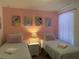 Bright bedroom featuring twin beds, Disney themed decor, soft pastel colors, and wood-look flooring at 2514 Dharma Cir, Kissimmee, FL 34746