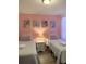 Bright bedroom featuring twin beds, Disney themed decor, soft pastel colors, and wood-look flooring at 2514 Dharma Cir, Kissimmee, FL 34746