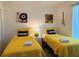 Bright twin bedroom featuring playful music themed art and vibrant yellow bedding at 2514 Dharma Cir, Kissimmee, FL 34746