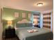 Serene bedroom featuring tranquil colors, soft bedding, and stylish striped curtains at 2514 Dharma Cir, Kissimmee, FL 34746