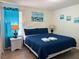 Stylish bedroom with soft bedding, nautical art, and calming blue accents at 2514 Dharma Cir, Kissimmee, FL 34746