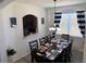 Charming dining area with seating for eight, complemented by elegant decor and natural light at 2514 Dharma Cir, Kissimmee, FL 34746