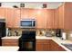Spacious kitchen features stainless steel appliances, ample countertop space, and stylish tile backsplash at 2514 Dharma Cir, Kissimmee, FL 34746