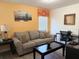 Comfortable living room with a cozy sofa, modern decor, and a dedicated workspace at 2514 Dharma Cir, Kissimmee, FL 34746