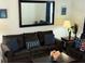 Comfortable living room featuring a large mirror, modern decor, and cozy seating arrangement at 2514 Dharma Cir, Kissimmee, FL 34746