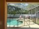 Screened-in pool with a jacuzzi and -safety fence seen from covered patio at 2514 Dharma Cir, Kissimmee, FL 34746