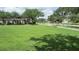 Well-maintained community green space with sidewalks and seating area amidst lush greenery at 2673 Rainbow Springs Ln, Orlando, FL 32828