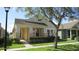 Inviting curb appeal, featuring a covered porch with stately columns and a landscaped front yard at 2673 Rainbow Springs Ln, Orlando, FL 32828