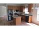 Modern kitchen featuring stainless steel appliances, granite countertops, and a center island at 2673 Rainbow Springs Ln, Orlando, FL 32828