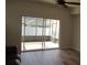 Living area featuring large sliding doors to a screened-in lanai, perfect for outdoor relaxation at 2673 Rainbow Springs Ln, Orlando, FL 32828