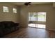 Bright living room with sliding glass doors leading to a screened lanai and backyard at 2673 Rainbow Springs Ln, Orlando, FL 32828