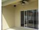 Covered outdoor patio includes a ceiling fan and sliding glass door entrance at 2673 Rainbow Springs Ln, Orlando, FL 32828