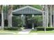 Open-air community pavilion with seating, set amidst lush greenery and mature palm trees for relaxation at 2673 Rainbow Springs Ln, Orlando, FL 32828