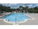 Large community swimming pool with sun loungers at 2673 Rainbow Springs Ln, Orlando, FL 32828