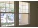 Window offering a view of the well-maintained exterior landscaping at 2673 Rainbow Springs Ln, Orlando, FL 32828