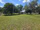 Property featuring a spacious backyard with mature trees and lush green grass at 2704 Sample St, Kissimmee, FL 34744