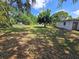 View of a spacious backyard with mature trees enhancing privacy and shade at 2704 Sample St, Kissimmee, FL 34744