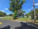 Property featuring a cozy home with a well-maintained lawn and mature trees at 2704 Sample St, Kissimmee, FL 34744