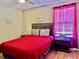 Cozy bedroom with a comfortable bed, bedside table, and a colorful window curtain at 2734 Rio Grande Trl # 2734, Kissimmee, FL 34741