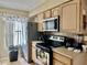 Functional kitchen equipped with stainless steel appliances and wooden cabinets at 2734 Rio Grande Trl # 2734, Kissimmee, FL 34741
