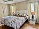 Well-lit main bedroom showcasing a comfortable bed, stylish lamps, and wood flooring at 2734 Rio Grande Trl # 2734, Kissimmee, FL 34741