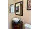 Bathroom featuring a stand alone bowl sink, black cabinet, and wooden framed mirror at 2779 Theresa Dr, Kissimmee, FL 34744