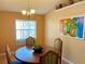 Cozy dining room featuring warm lighting, comfortable seating, and a view of the backyard at 2779 Theresa Dr, Kissimmee, FL 34744