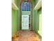 Close up of the home's entrance, with a charming tile design, brick accents, and a large picture window at 2779 Theresa Dr, Kissimmee, FL 34744