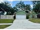 Charming single-Gathering home features a lush front lawn, mature trees, and a two-car garage at 2779 Theresa Dr, Kissimmee, FL 34744