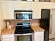 Kitchen with stainless steel microwave and oven at 2779 Theresa Dr, Kissimmee, FL 34744