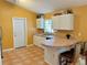 Eat-in kitchen with tile floors, breakfast bar and ample cabinet space at 2779 Theresa Dr, Kissimmee, FL 34744