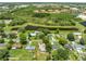 An aerial view of a property showcasing the lush greenery and the serene pond nearby at 2947 Larson St, Kissimmee, FL 34741