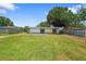 A sprawling backyard featuring a well-maintained lawn and mature tree providing shade to the property at 2947 Larson St, Kissimmee, FL 34741