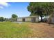 A sprawling backyard featuring a well-maintained lawn and mature tree providing shade to the property at 2947 Larson St, Kissimmee, FL 34741