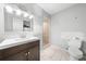 Bathroom featuring a modern vanity, toilet, and tiled walk-in shower at 2947 Larson St, Kissimmee, FL 34741