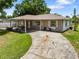 Inviting single-story home with a covered front porch and a classic stone exterior at 2947 Larson St, Kissimmee, FL 34741