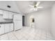 Bright kitchen with white cabinetry, a fridge, and tile flooring throughout at 2947 Larson St, Kissimmee, FL 34741