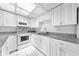 Bright kitchen featuring white cabinets, stainless steel appliances and tile flooring at 2947 Larson St, Kissimmee, FL 34741