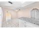 Bright kitchen with white cabinetry, granite countertops, tiled floors, and stainless steel appliances at 2947 Larson St, Kissimmee, FL 34741