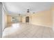 Spacious living room featuring tile floors, ceiling fans, and a large window allowing ample natural light at 2947 Larson St, Kissimmee, FL 34741
