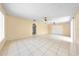 Spacious living room with light yellow walls and tile flooring throughout at 2947 Larson St, Kissimmee, FL 34741