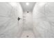 Modern shower stall featuring white marble-look tiles and bronze fixtures at 2947 Larson St, Kissimmee, FL 34741